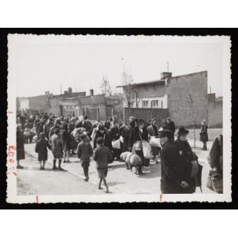 black and white photo of Jews moving through the streets of Lodz